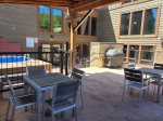 Outdoor common area patio with gas grills, seating, and hot tub.